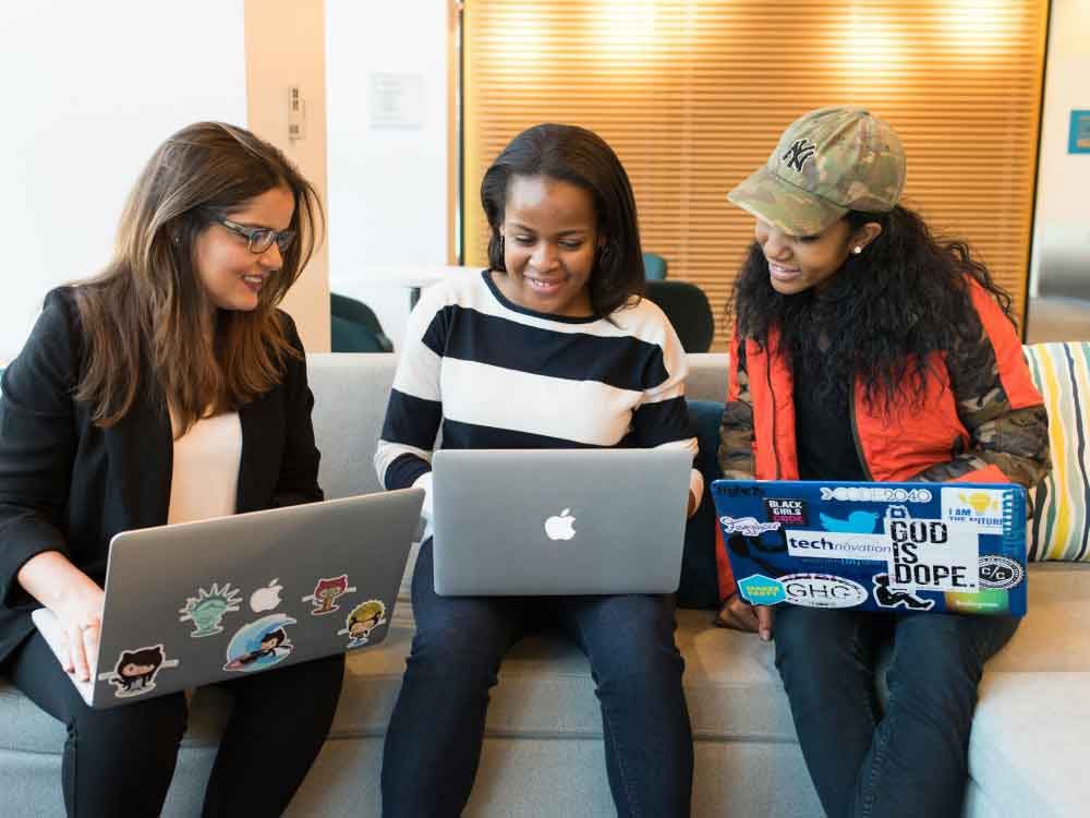 Women collaborating with their laptops